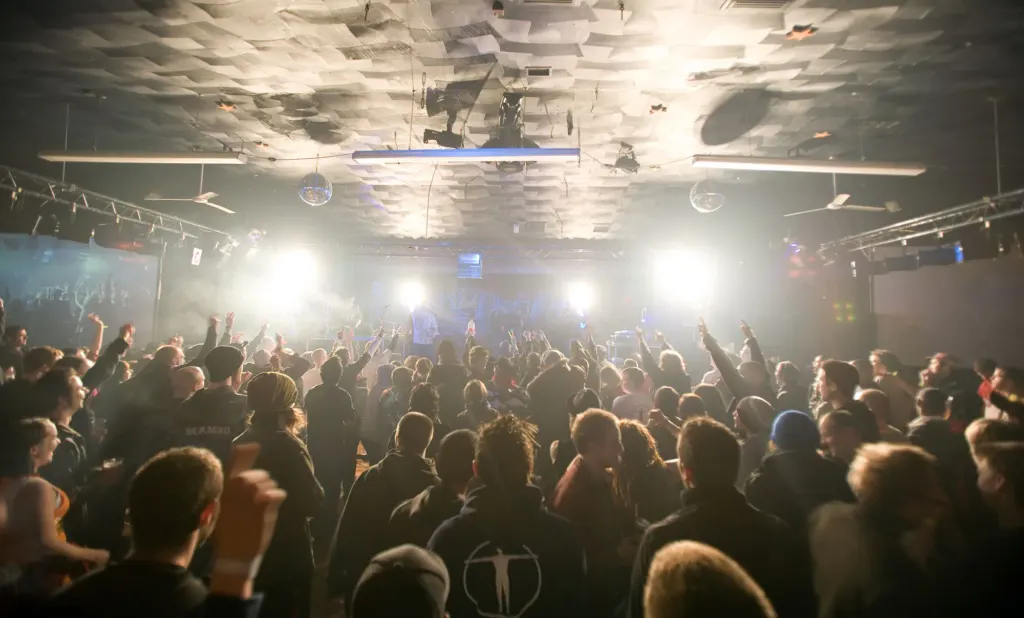Crowd facing a brightly lit stage at the first Bloc Weekend in Hemsby.